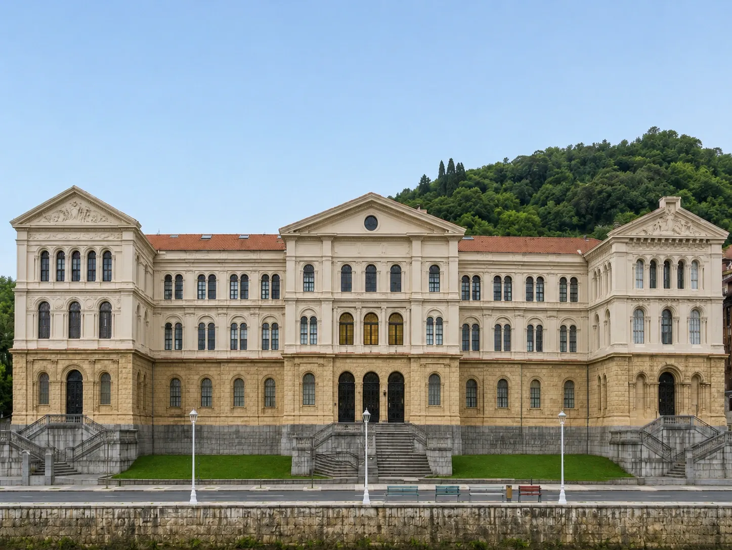 Front view of the historic University of Deusto building with ornate white façades and landscaped surroundings in Spain.